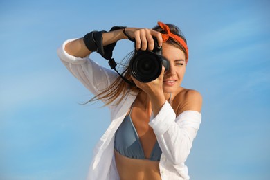 Photographer taking photo with professional camera outdoors