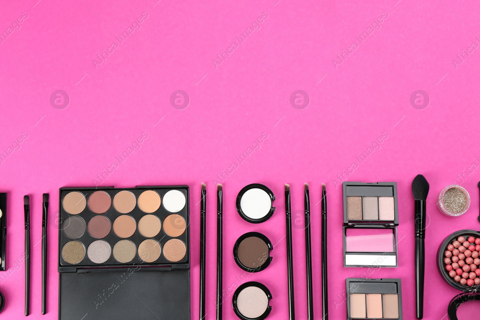 Photo of Flat lay composition with makeup brushes on bright pink background, space for text
