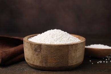 Tapioca pearls in bowl on wooden table, closeup