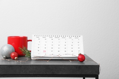 Photo of Calendar and festive decor on table. Christmas countdown