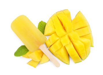 Photo of Tasty mango ice pop isolated on white, top view. Fruit popsicle