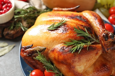 Delicious roasted turkey for traditional festive dinner on table, closeup