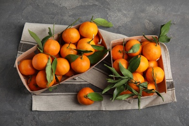 Flat lay composition with fresh ripe tangerines on grey background