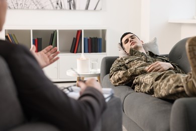 Photo of Professional psychotherapist working with military man in office