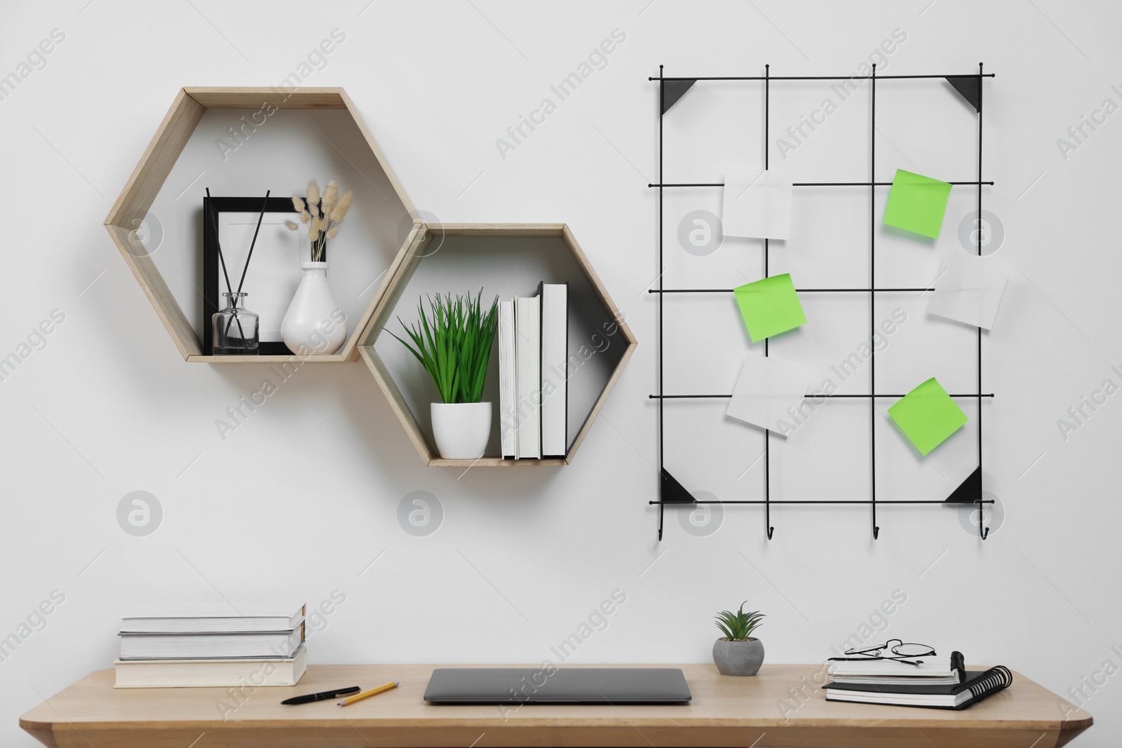 Photo of Home workspace. Laptop and stationery on wooden desk indoors