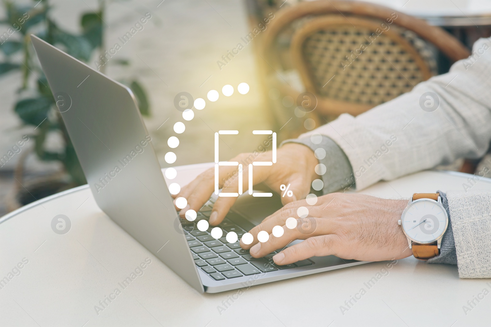 Image of Loading progress. Man working on laptop at table indoors, closeup