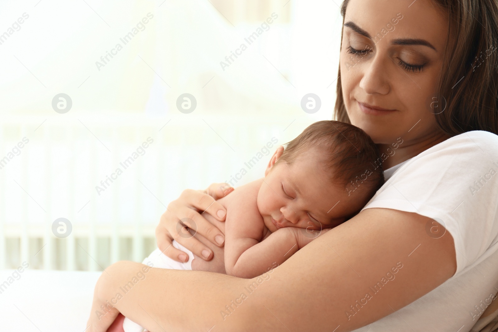 Photo of Young mother with her little baby at home