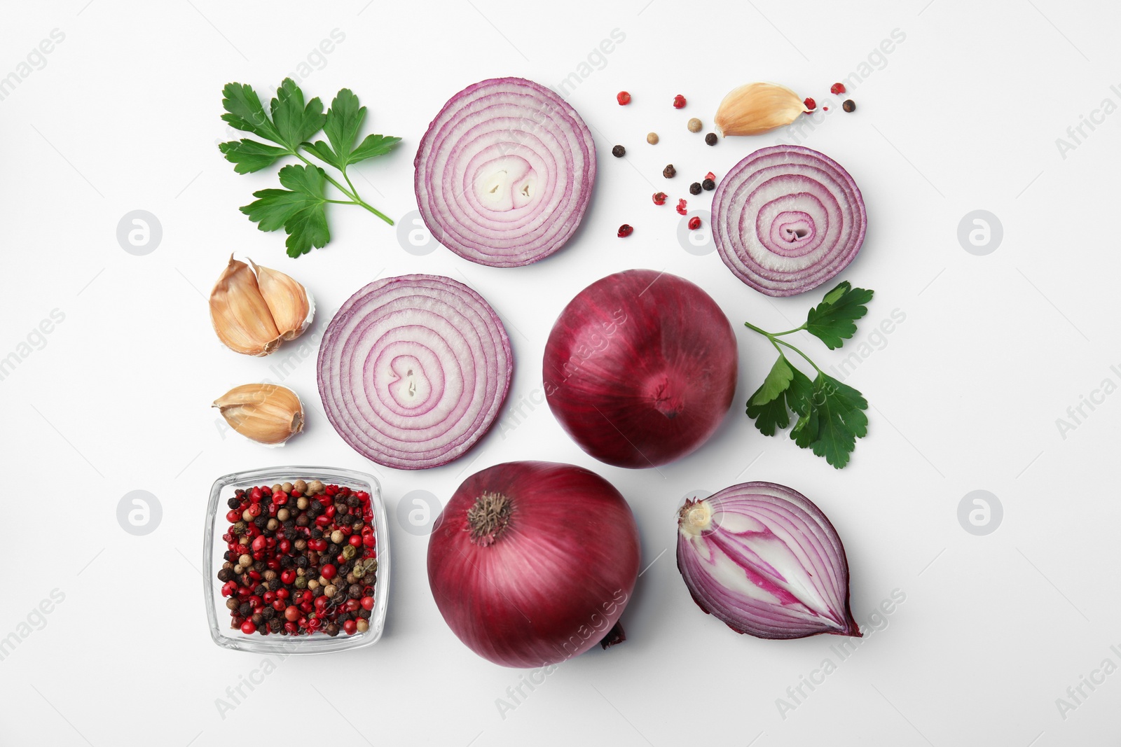 Photo of Fresh red onions, garlic, parsley and spices on white background, flat lay