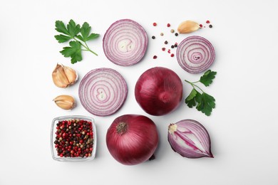 Fresh red onions, garlic, parsley and spices on white background, flat lay