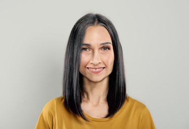 Image of Portrait of senior woman on light grey background