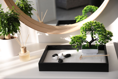 Photo of Beautiful miniature zen garden on white table indoors