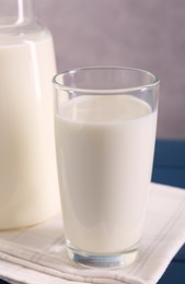 Photo of Glass of fresh milk on table, closeup
