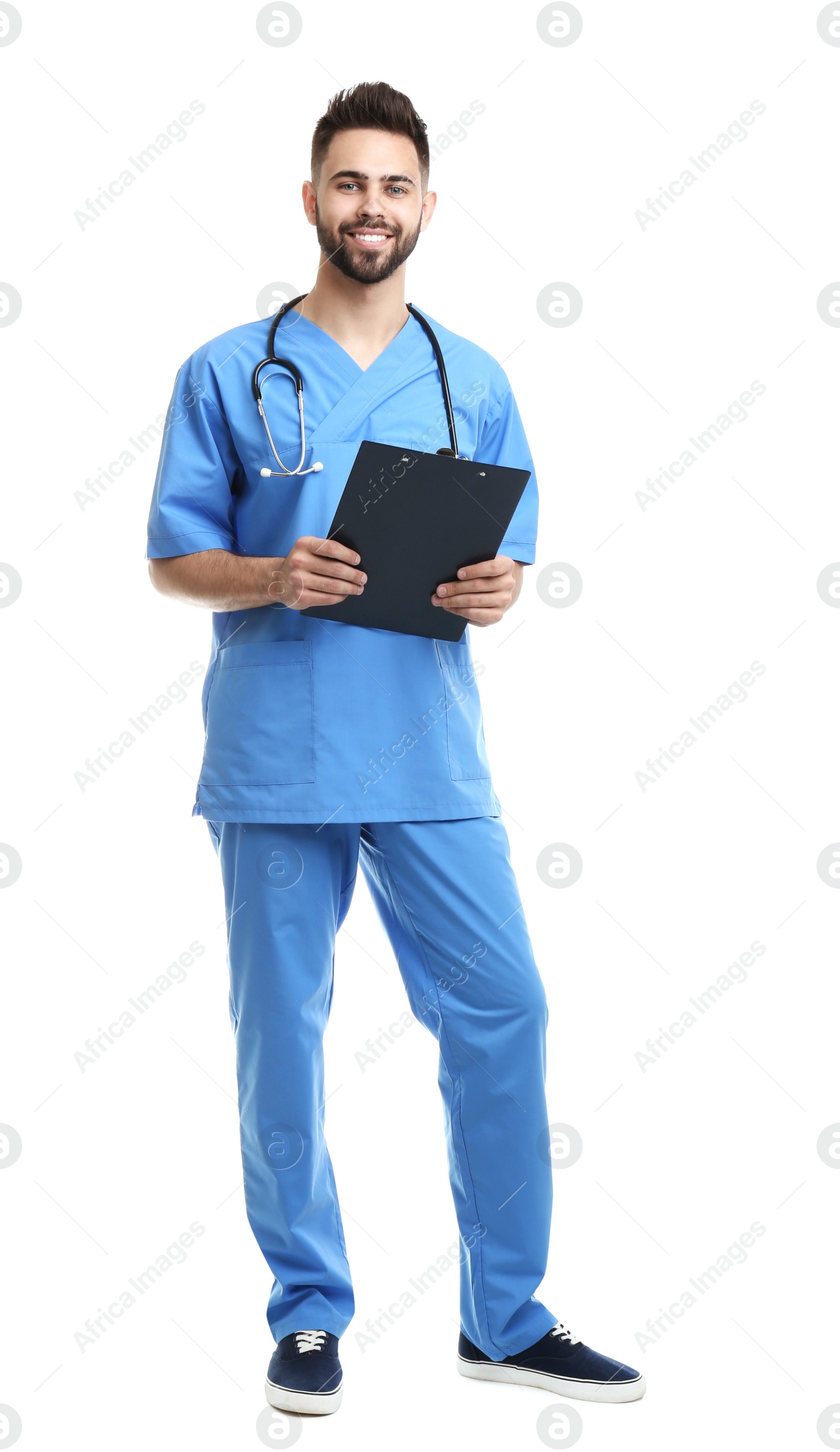 Photo of Young male doctor in uniform with clipboard isolated on white