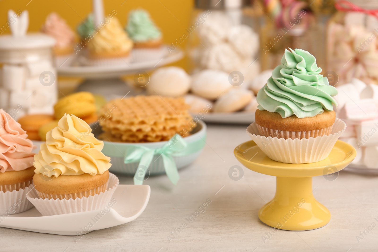 Photo of Tasty cupcakes and other sweets on table. Candy bar, closeup view