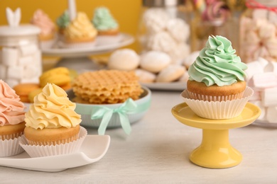 Photo of Tasty cupcakes and other sweets on table. Candy bar, closeup view