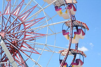 Large empty observation wheel against blue sky