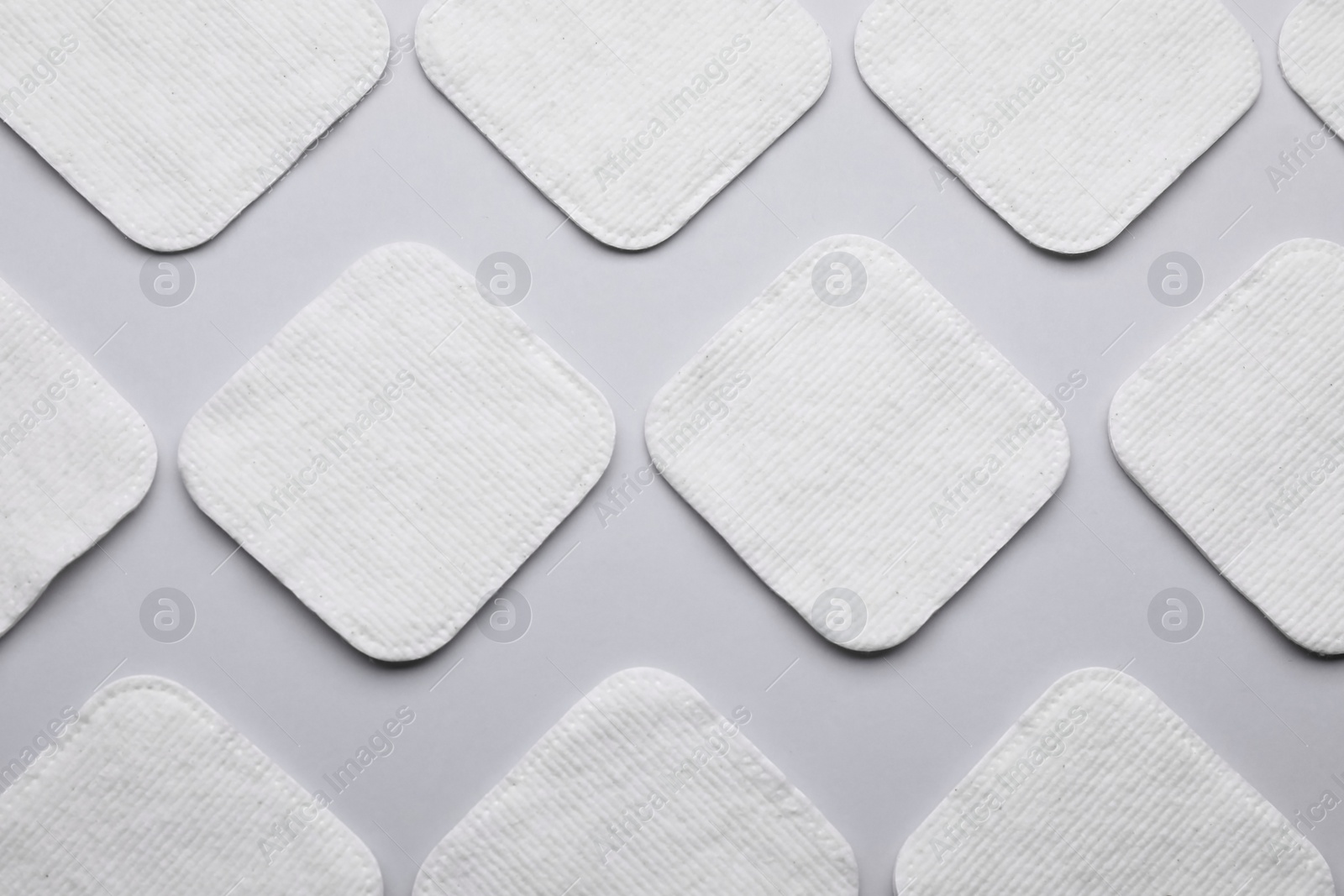 Photo of Many clean cotton pads on light grey background, flat lay