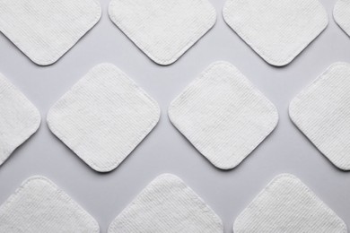 Photo of Many clean cotton pads on light grey background, flat lay