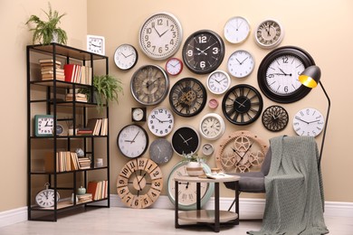 Stylish room interior with collection of wall clocks