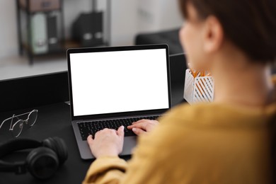 Photo of Woman watching webinar at table in office, closeup