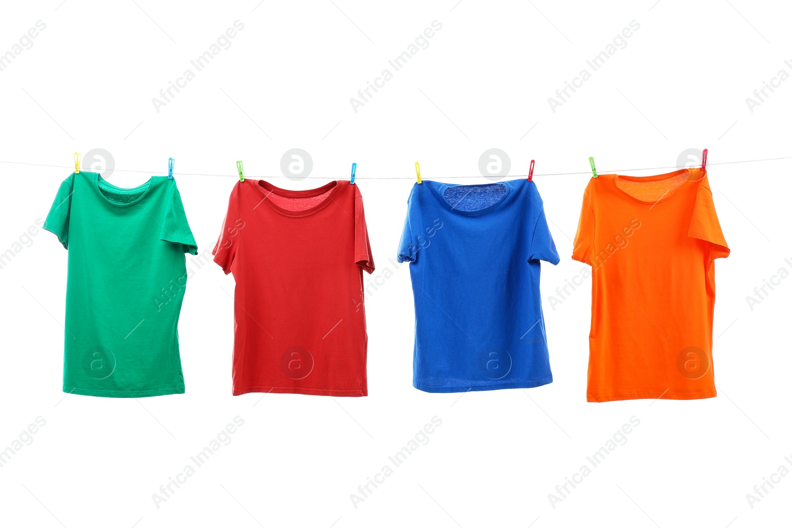 Photo of Colorful t-shirts drying on washing line isolated on white