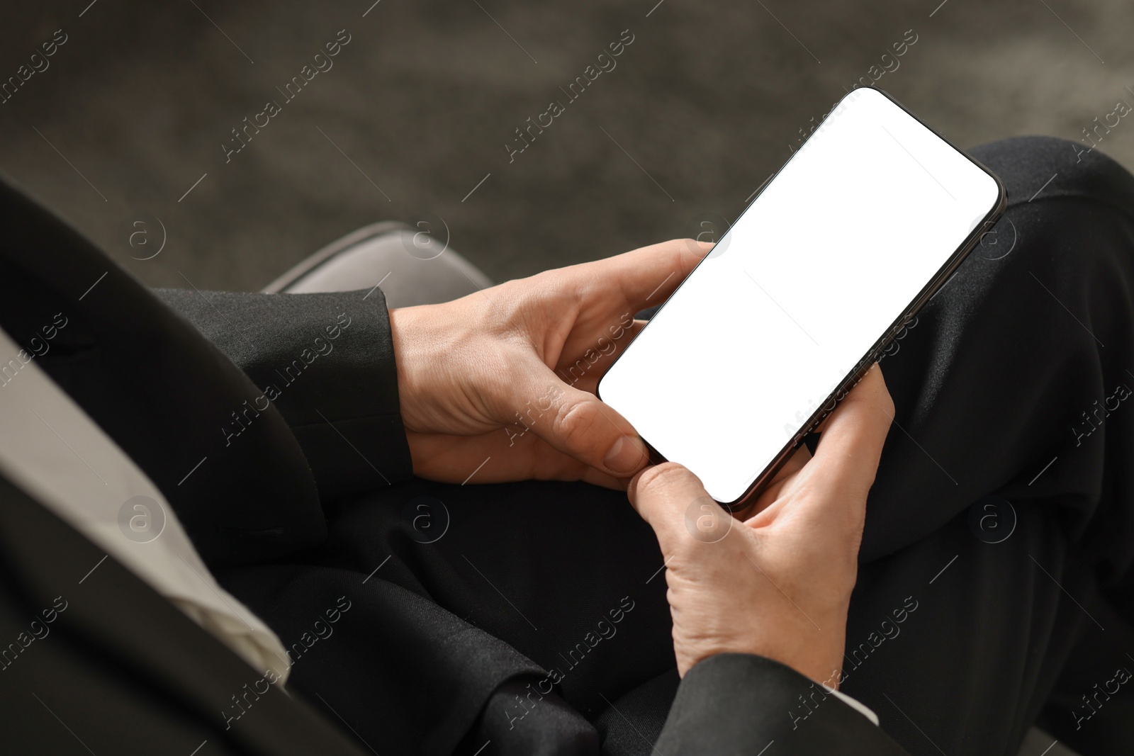 Photo of Man using smartphone with blank screen indoors, closeup. Mockup for design