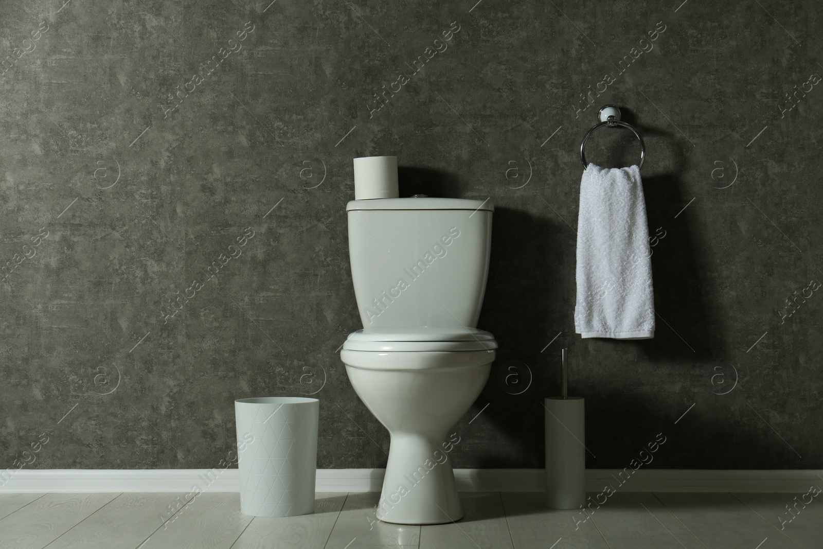 Photo of Simple bathroom interior with new toilet bowl near grey wall