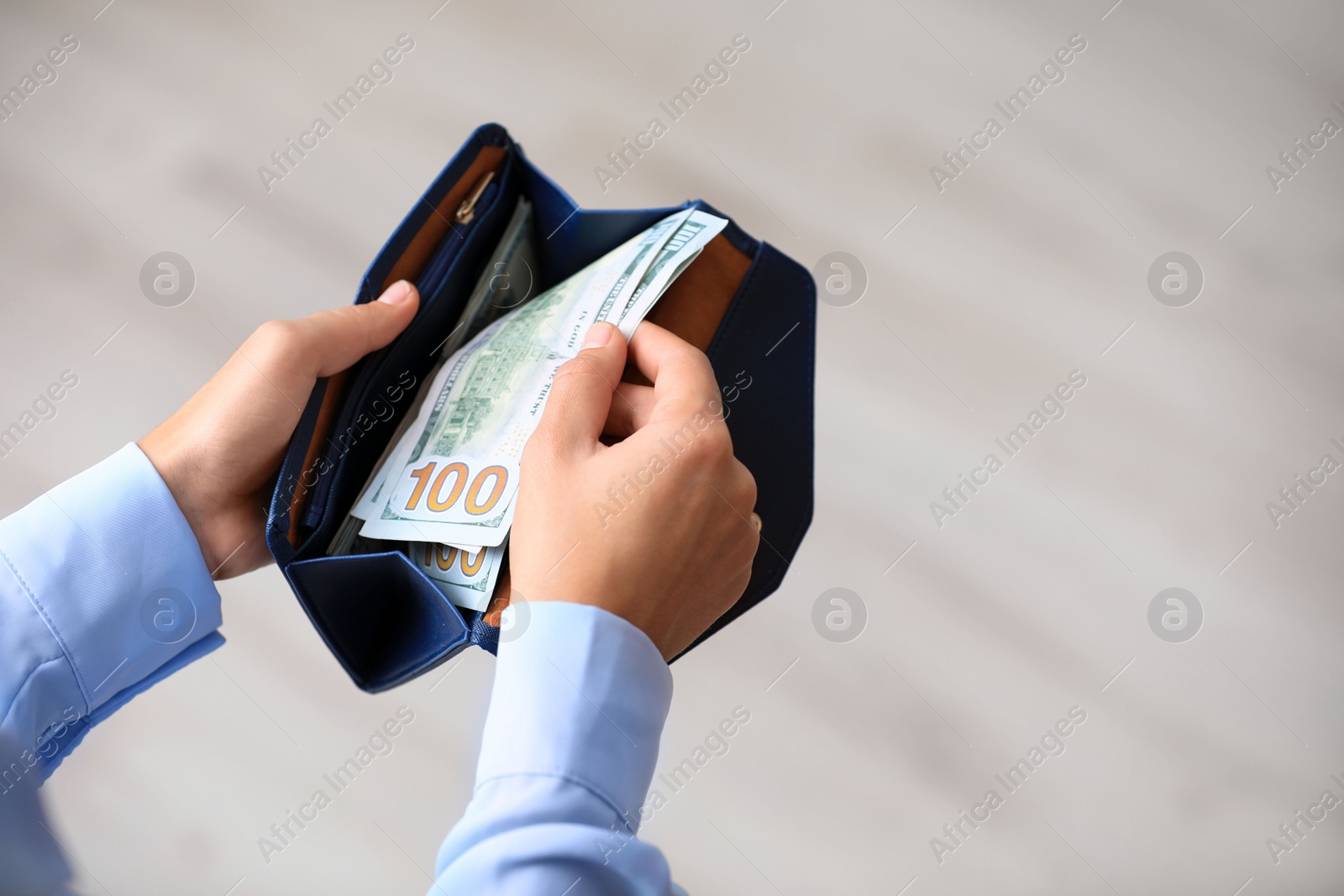 Photo of Woman with American money in wallet, closeup