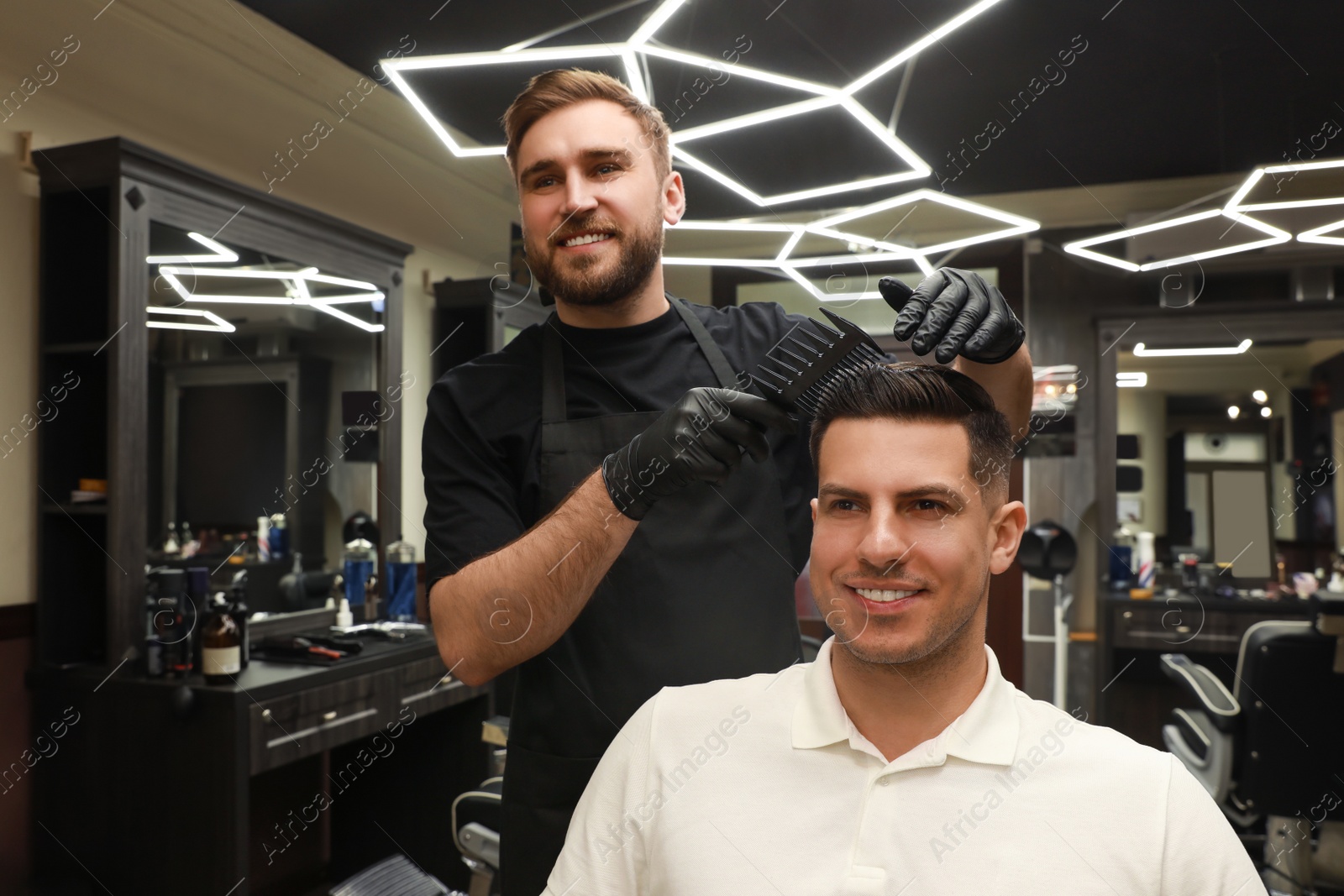 Photo of Professional hairdresser making stylish haircut in salon