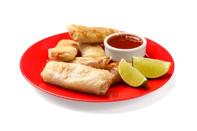 Photo of Tasty fried spring rolls, lime and sauce isolated on white