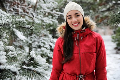 Happy young woman outdoors on winter day. Space for text