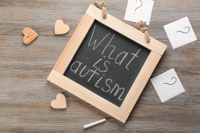 Photo of Chalkboard with phrase "What is autism?" on wooden background