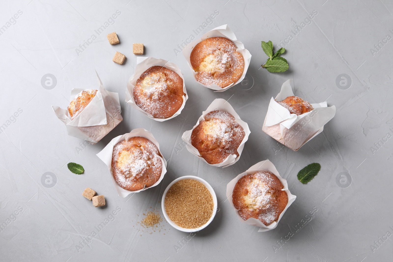 Photo of Delicious muffins on grey table, flat lay