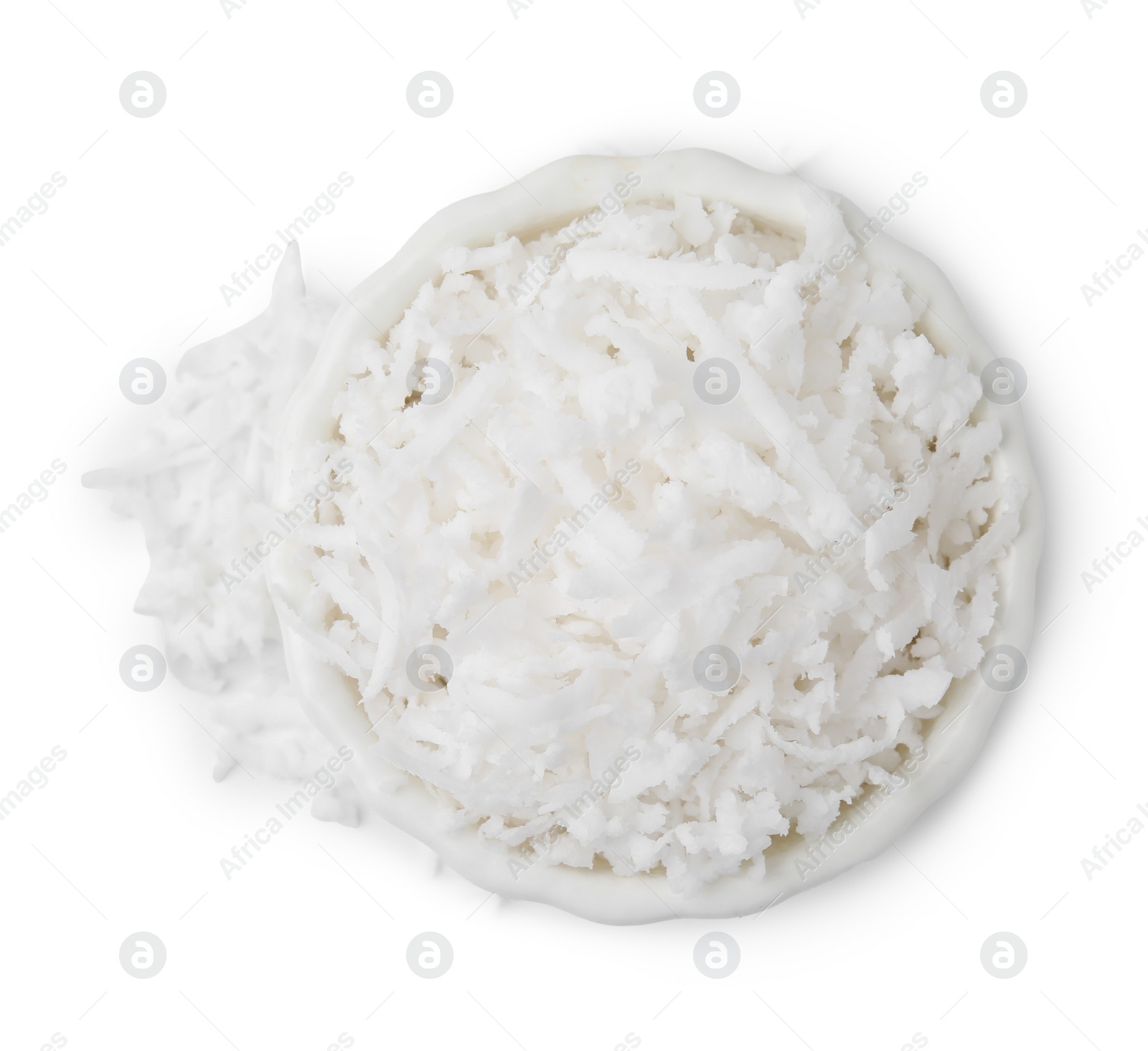 Photo of Coconut flakes in bowl isolated on white, top view