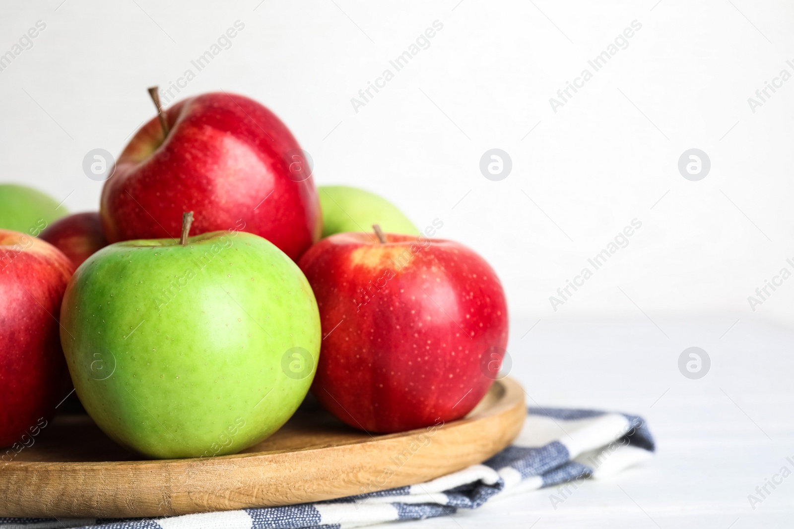 Photo of Different ripe apples on table against white background. Space for text