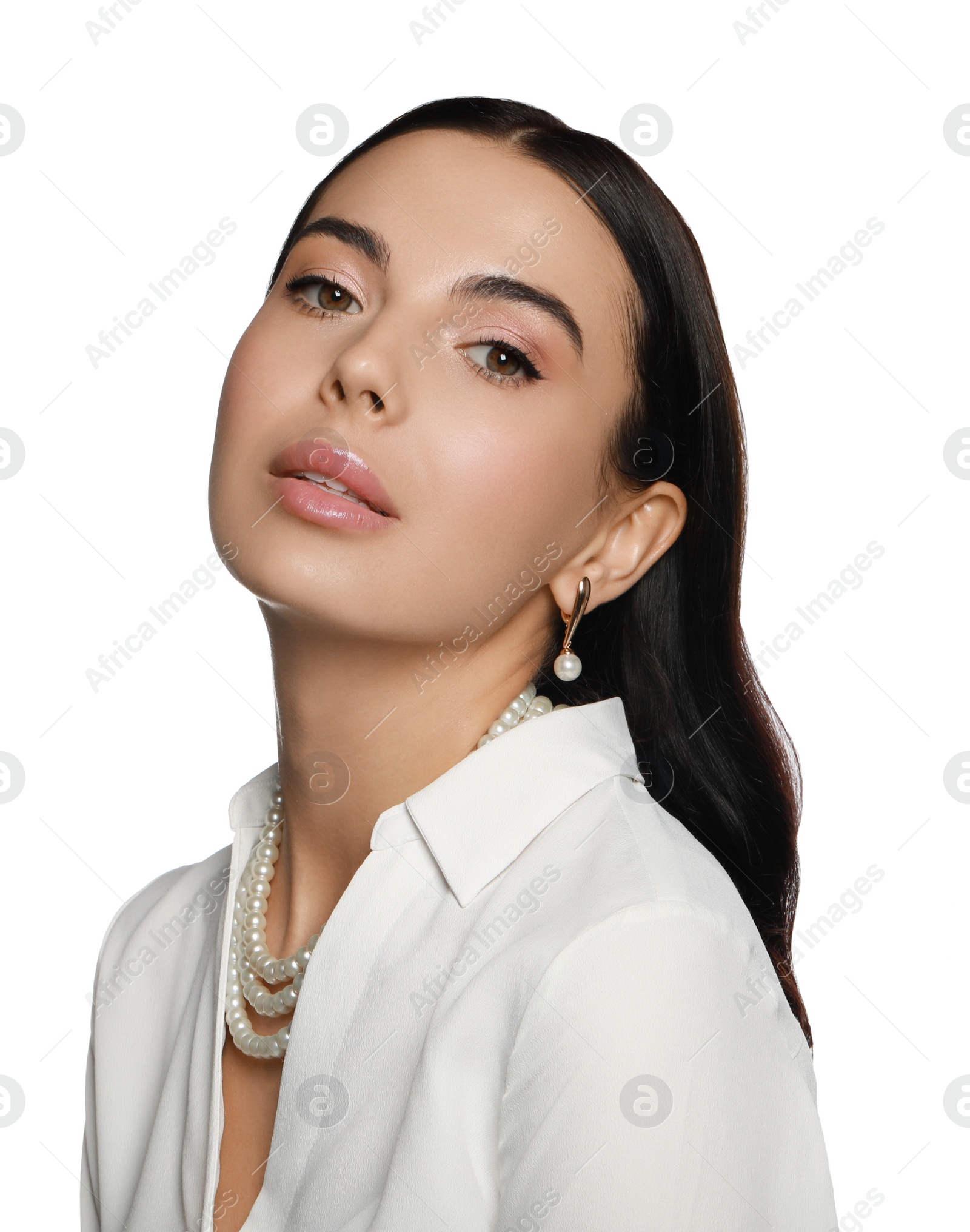 Photo of Young woman wearing elegant pearl jewelry on white background