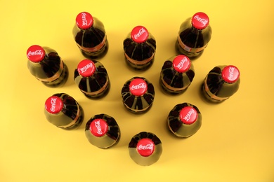 MYKOLAIV, UKRAINE - NOVEMBER 14, 2018: Bottles of Coca-Cola on color background, above view