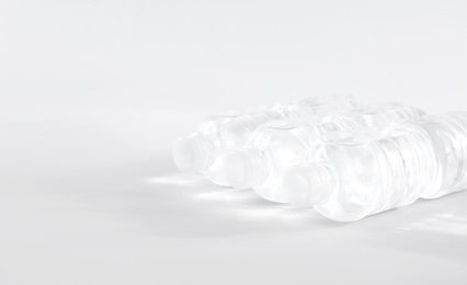 Plastic bottles with pure water on white background