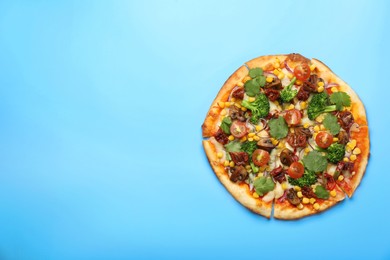 Photo of Delicious vegetarian pizza with mushrooms, vegetables and parsley on light blue background, top view. Space for text