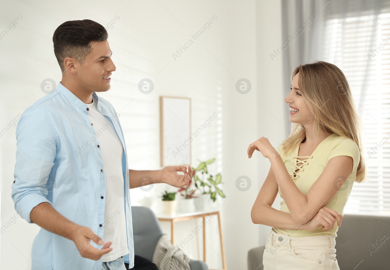 Photo of Man and woman talking in living room