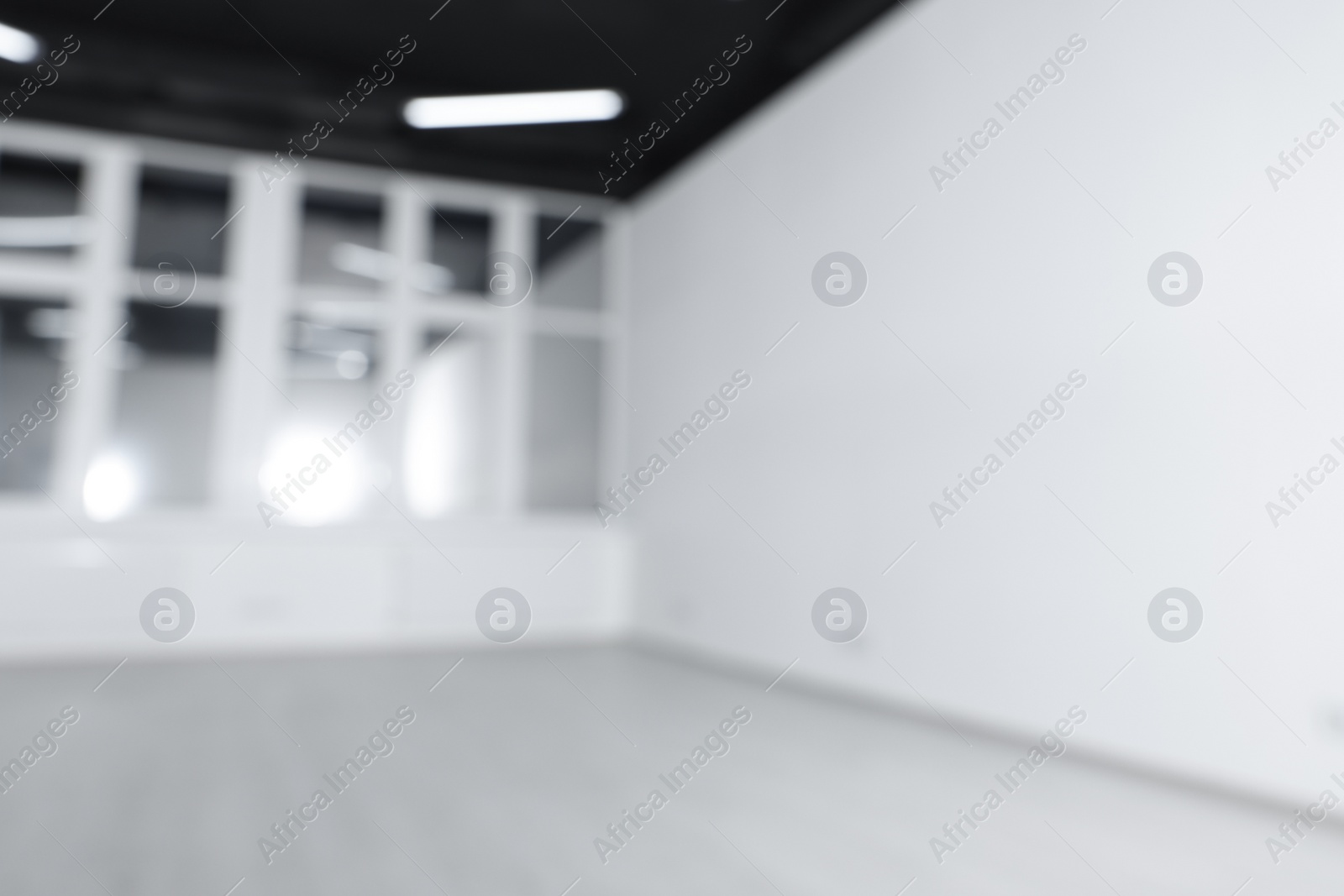 Photo of Blurred view of new empty room with windows