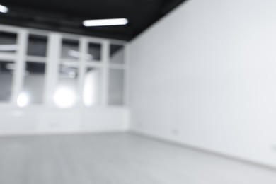 Blurred view of new empty room with windows