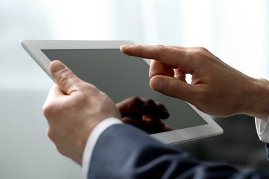 Closeup view of man using new tablet indoors