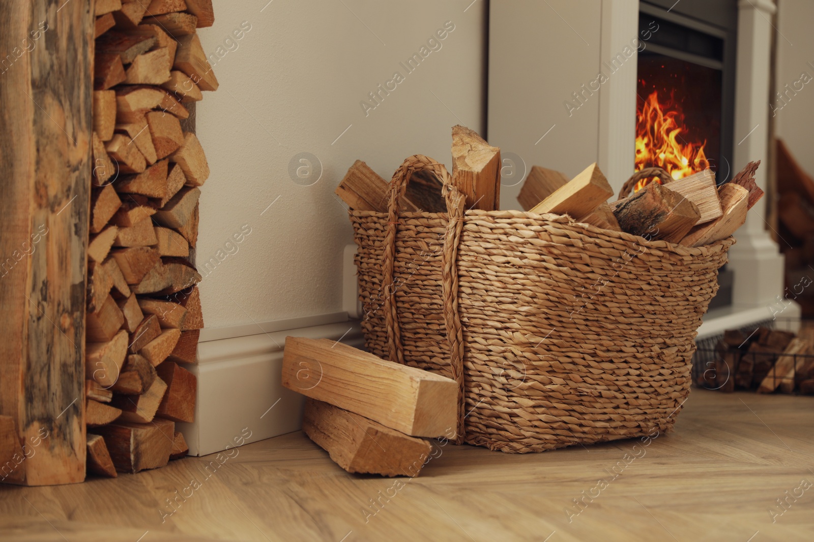 Photo of Basket with firewood on floor in room