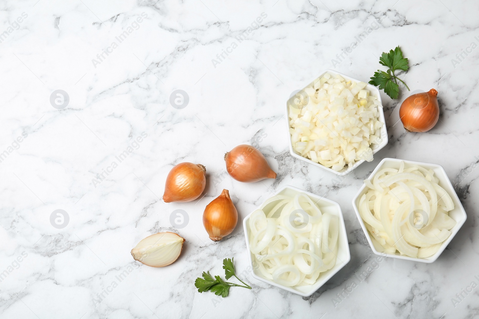 Photo of Flat lay composition with fresh ripe onions on marble table