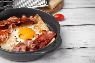 Photo of Delicious crepe with egg and bacon in dish on white wooden table. Breton galette