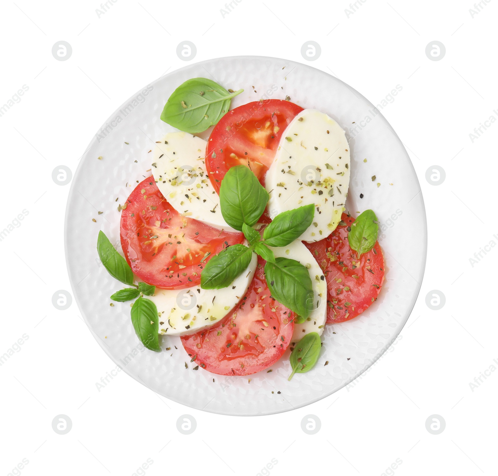 Photo of Plate of delicious Caprese salad with herbs isolated on white, top view