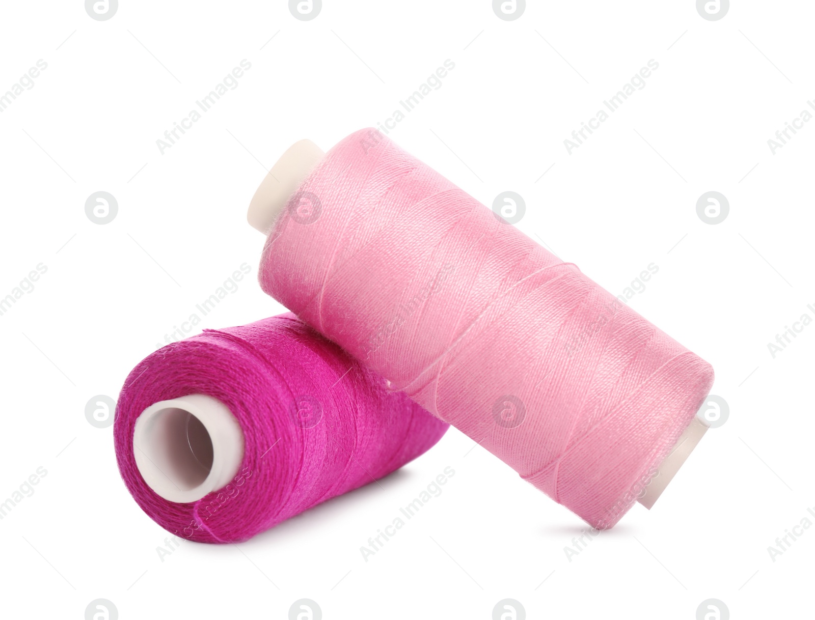 Photo of Different colorful sewing threads on white background