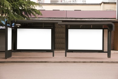 Photo of Blank advertising boards on transport stop. Space for design