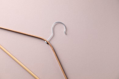 Photo of One wooden hanger on beige background, top view. Space for text